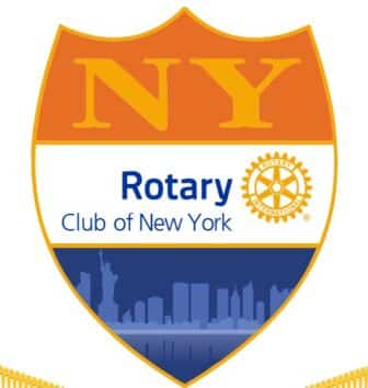 A shield-shaped emblem with NY at the top, Rotary Club of New York in the center, the Rotary International logo, and a blue silhouette of the New York City skyline and the Statue of Liberty at the bottom.